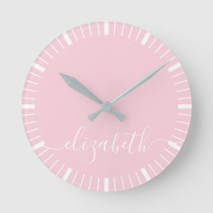pastel pink with white script signature - minimal round clock