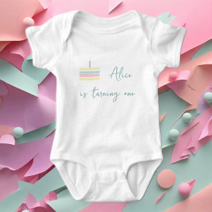 Pastel pink yellow cake is turning one baby bodysuit