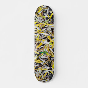 Pattern of the falling leaves on black skateboard