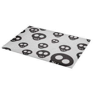 Pattern with black skulls on white cutting board