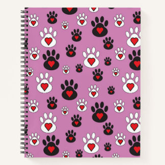 Paw prints with red hearts on pink notebook
