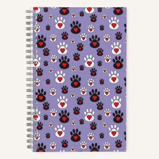 Pawprints with red hearts on blue notebook
