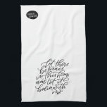 Peace in this Home Tea Towel<br><div class="desc">Bring peace to your kitchen with this sweet hand lettered hand towel. When folded in half,  the phrase on the front reads “let there be peace in this home and let it begin with me”. Reverse side has a small bubble with the wording “peace (& quiet)”.</div>