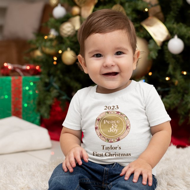 Peace & Joy Pink Gold Baby First Christmas Baby T-Shirt (Peace & Joy Pink Gold Baby First Christmas Baby T-Shirt with dark-colored text for light shirts.)