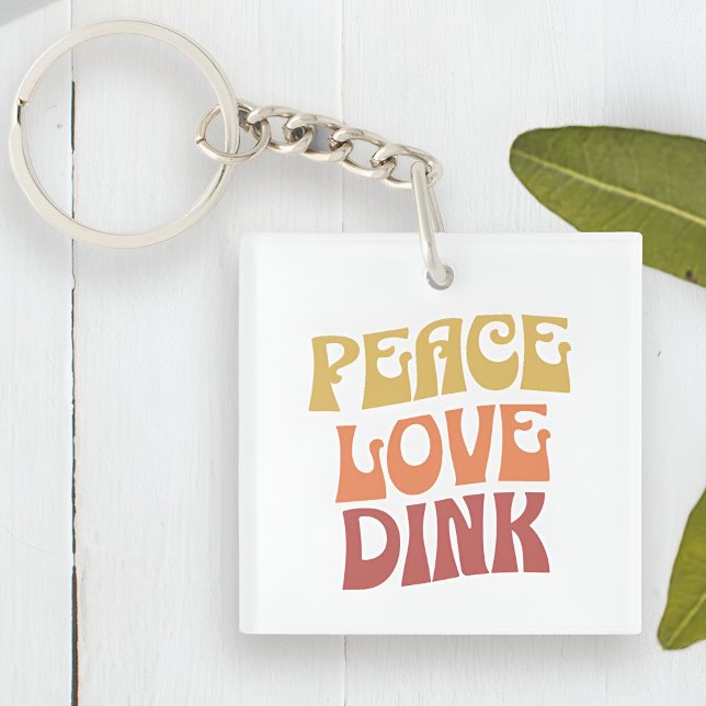 Peace Love Dink Double Sided Acrylic Keychain (Peace Love Dink Double Sided Acrylic Keychain Next to a Plant)