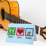 Peace Love Guitar Holiday Card<br><div class="desc">A cool guitarist Christmas card featuring a peace sign,  heart,  and a guitar on a beautiful blue background. A cute musical instrument store holiday card that reads Peace Love Guitar.</div>
