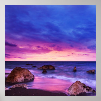 Peaceful Beach Sunset with Rocks and cloudy sky Poster