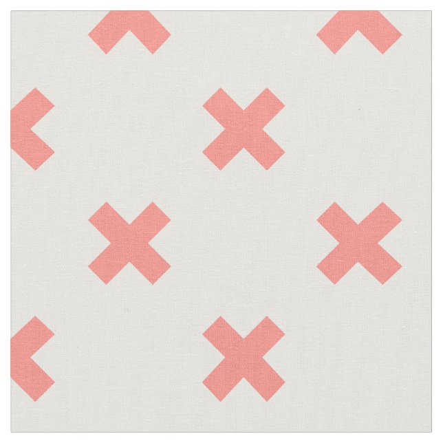 Peach cross stitches on white fabric (Close Up)