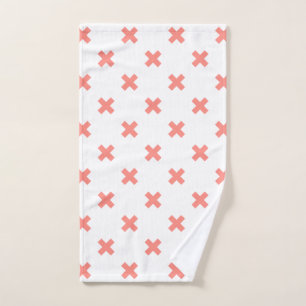 Peach cross stitches on white hand towel