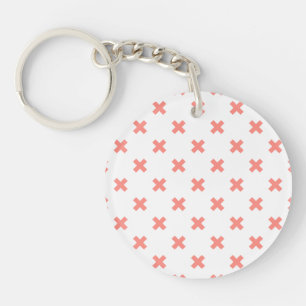 Peach cross stitches on white key ring