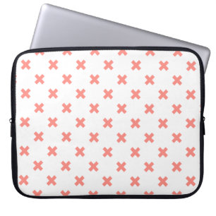 Peach cross stitches on white laptop sleeve