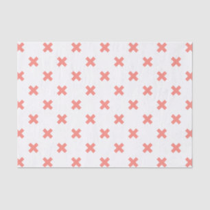 Peach cross stitches on white tissue paper