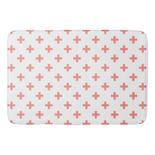 Peach polka crosses on white bath mat