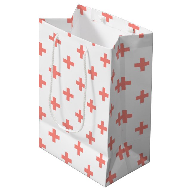 Peach polka crosses on white medium gift bag (Front Angled)