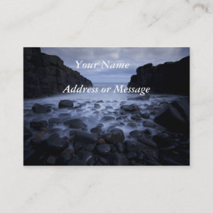 Pebbles and rocks along the ocean shoreline. busin business card