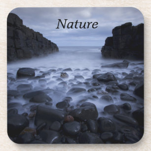 Pebbles and Rocks along the Ocean Shoreline Coaste Coaster