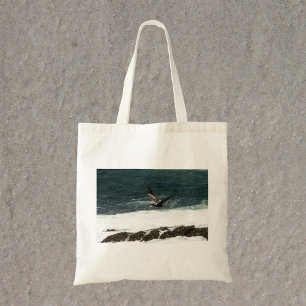Pelican Flying Over Pacific Ocean Photo Tote Bag