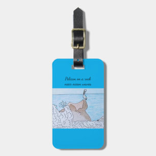Pelican on a rock near ocean waves luggage tag