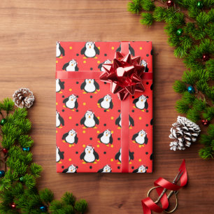 Penguins in christmas mood on red  wrapping paper