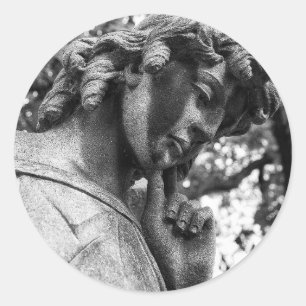 Pensive angel looking down classic round sticker