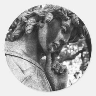 Pensive angel looking down classic round sticker