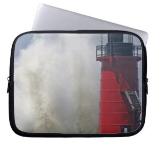 People on jetty watch large breaking waves in laptop sleeve