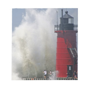 People on jetty watch large breaking waves in notepad