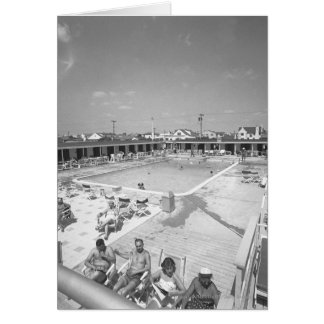People relaxing at outdoor swimming pool B&W