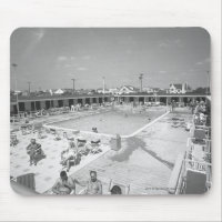 People relaxing at outdoor swimming pool B&W
