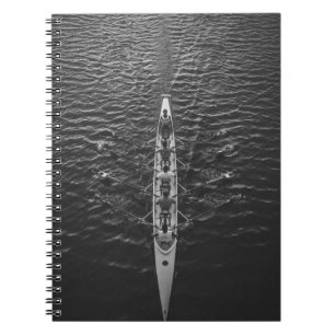 PEOPLE RIDING BOAT ON BODY OF WATER NOTEBOOK