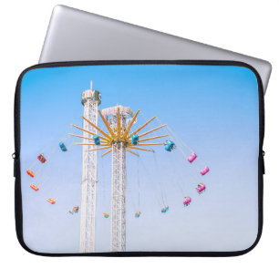 People riding swing amusement ride low-angle photo laptop sleeve