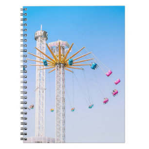 People riding swing amusement ride low-angle photo notebook