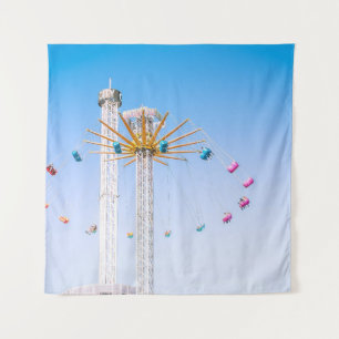 People riding swing amusement ride low-angle photo tapestry