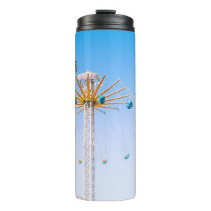 People riding swing amusement ride low-angle photo thermal tumbler