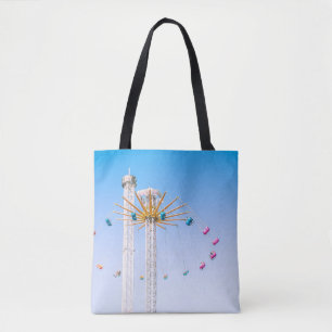 People riding swing amusement ride low-angle photo tote bag