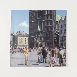 PEOPLE STANDING BESIDE CONCRETE CATHEDRAL TAPESTRY