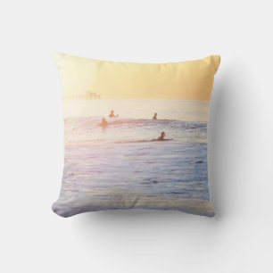 People surfing on beach cushion