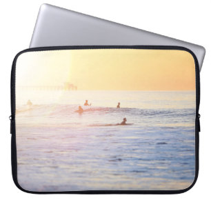 People surfing on beach laptop sleeve