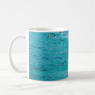 People swimming in the beach coffee mug