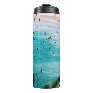 People swimming in the beach thermal tumbler