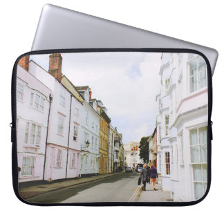 PEOPLE WALKING ON SIDEWALK BESIDE BUILDING AND ROA LAPTOP SLEEVE