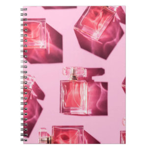 Perfume bottles, pink background, flatlay notebook