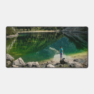 Person at mountain lake desk mat