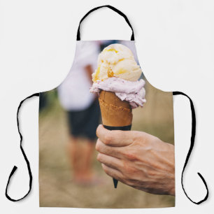 Person holding ice cream on cone apron