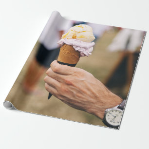 Person holding ice cream on cone wrapping paper
