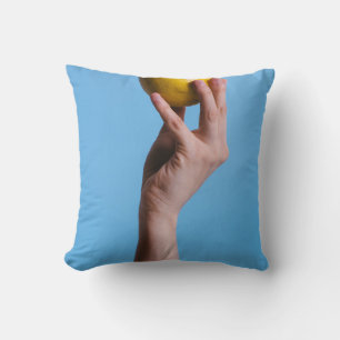 Person holding lemon cushion