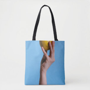 Person holding lemon tote bag