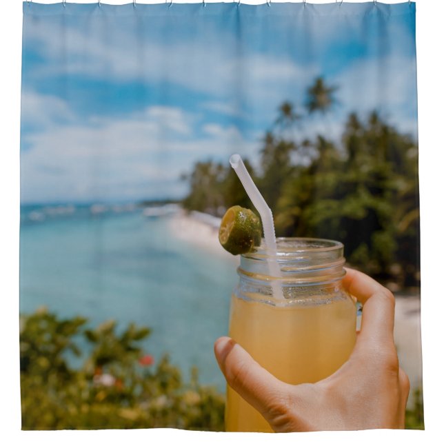 Person holding mason jar with filled with juice at shower curtain (Front)