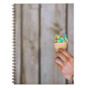Person holding multicolored ice cream notebook