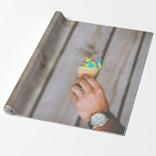 Person holding multicolored ice cream wrapping paper